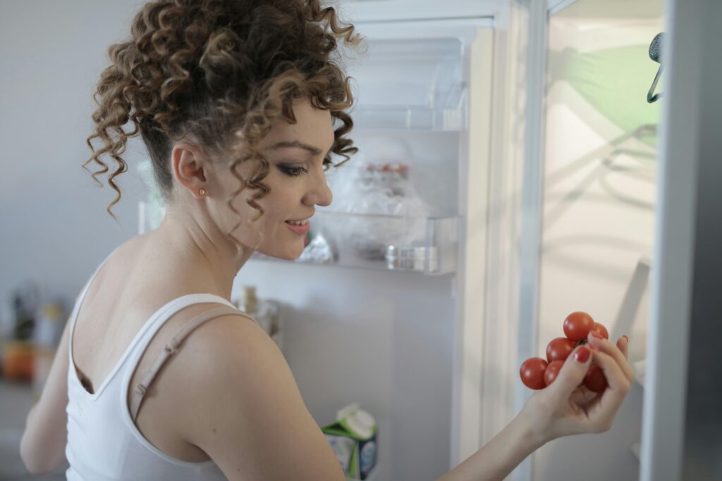 Person about to enjoy some fresh cherry tomatoes from the propane refrigerator